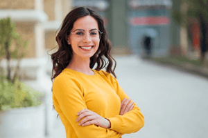 woman with confident smile standing outdoors