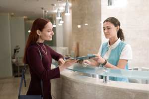 patient paying for treatment at dental office front desk