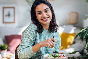Woman sitting at a table, enjoying a nutritious meal
