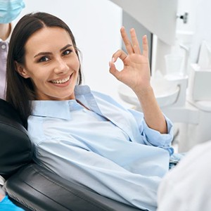Happy dental patient making OK sign