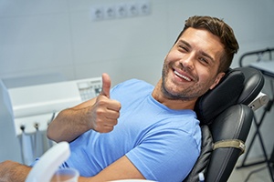 Male dental patient making thumbs up gesture