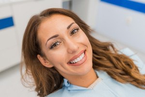 Close-up of happy dental patient with straight teeth