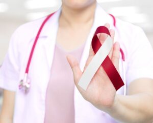 Medical professional holding oral cancer ribbon