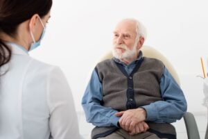 senior patient talking with his dentist